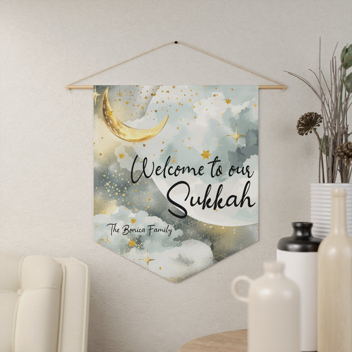 Decorative wall hanging with 'Welcome to our Sukkah' text on a light background