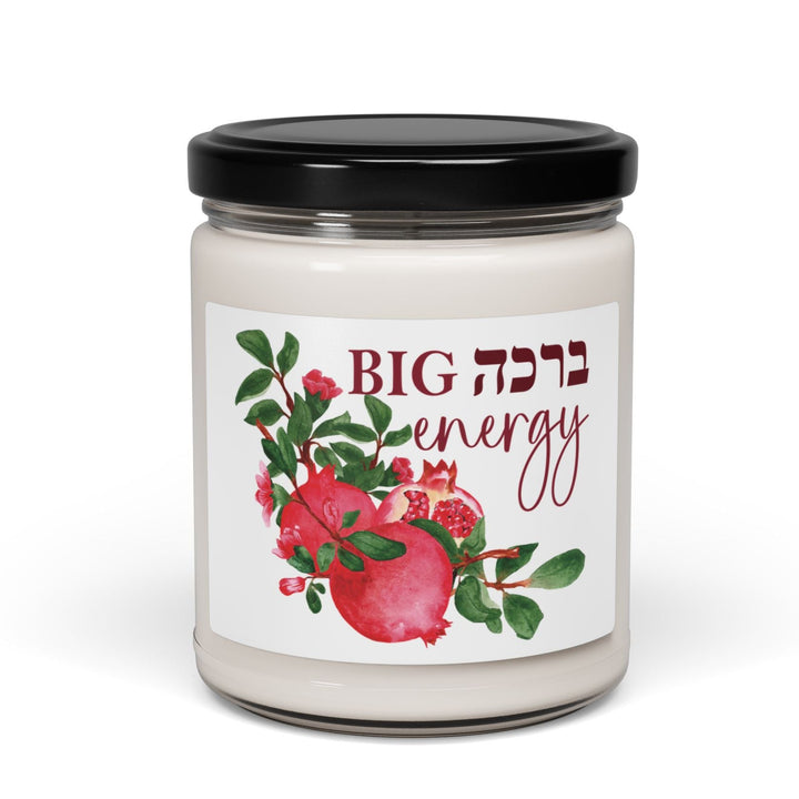 Candle jar with a decorative label featuring pomegranates and Hebrew text on a white background