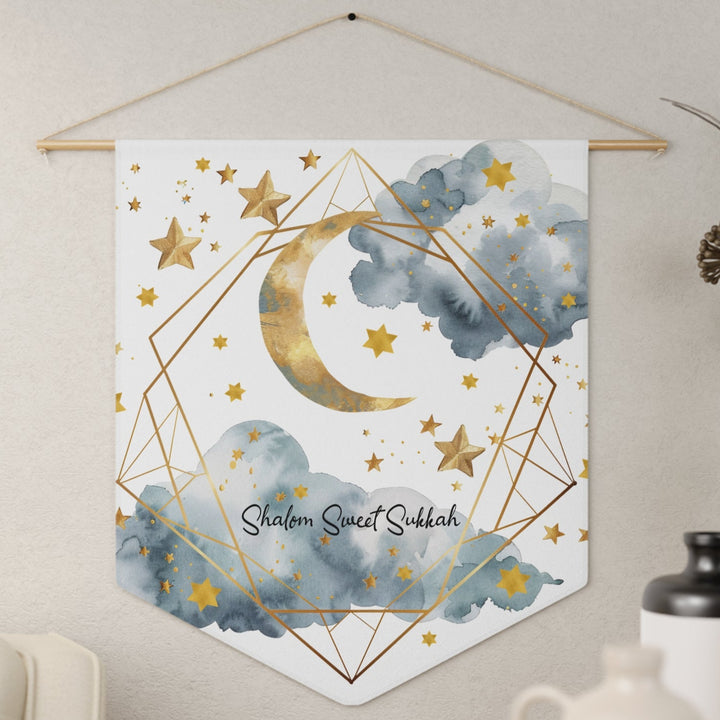 Decorative wall hanging with moon, stars, and geometric design on a white background, featuring the text 'Shalom Sweet Sukkah'.