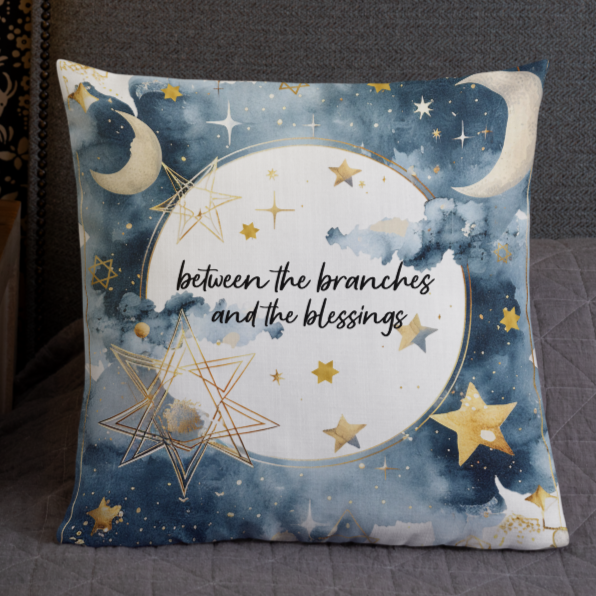 Decorative pillow with celestial design on a gray sofa