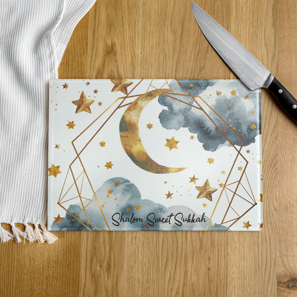 Decorative cutting board with star and moon design on a wooden surface
